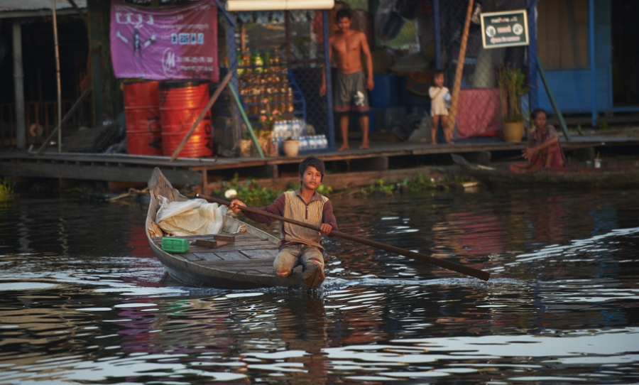 Boy rowing boat in Siem Reap.