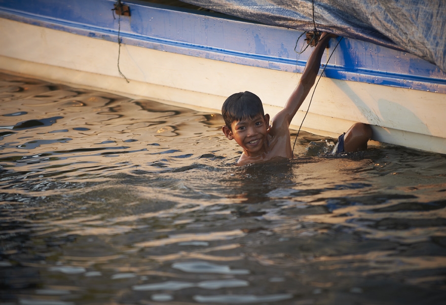 Boy playing in river in Siem Reap, Cambodia.