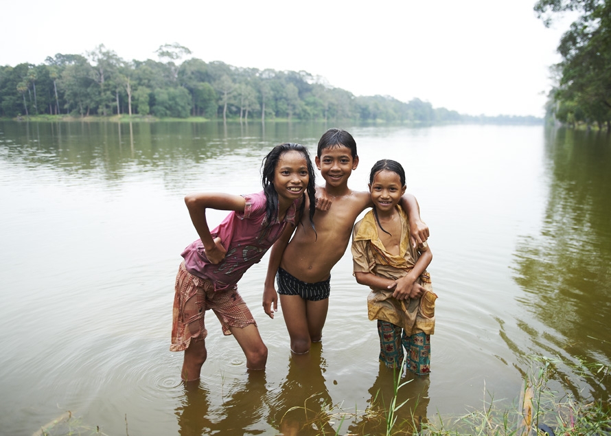 Children standing in river, Cambodia.