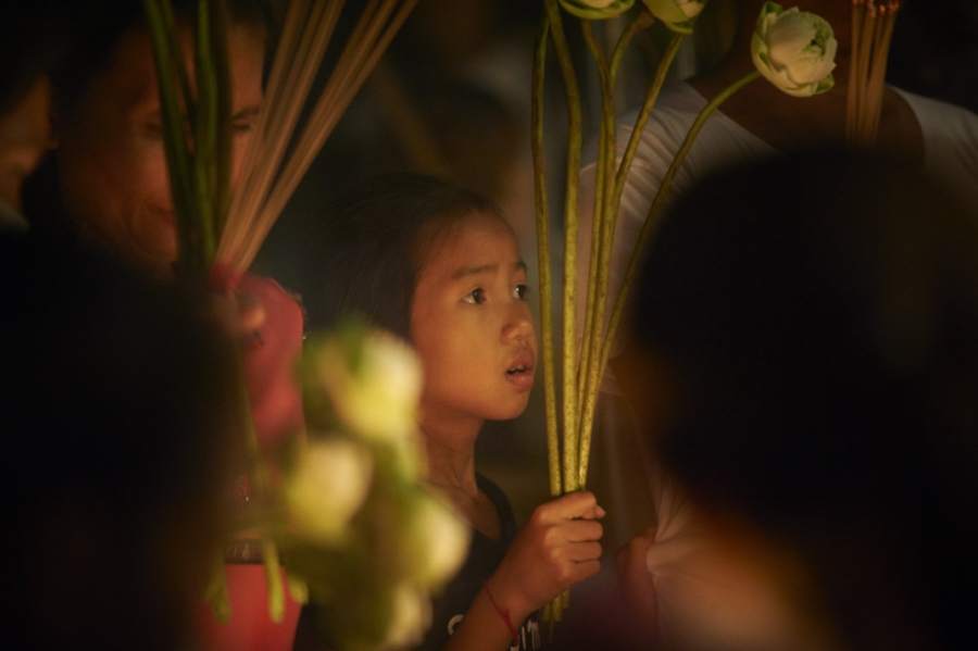 Child holding flowers.