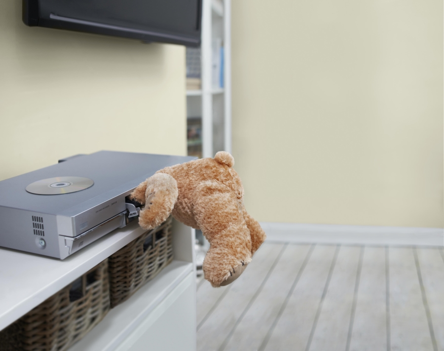Teddy with head stuck in DVD player.