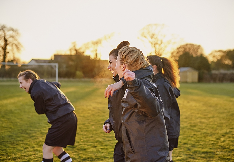 Female Football Team Celebrating 