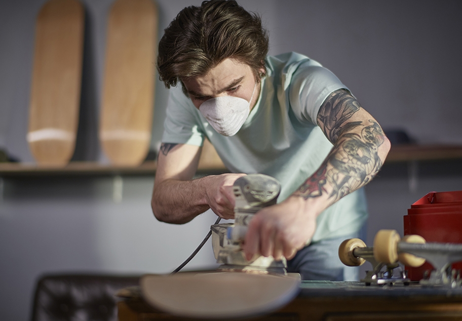 Getty Images: Male Sanding Skateboard in Workshop