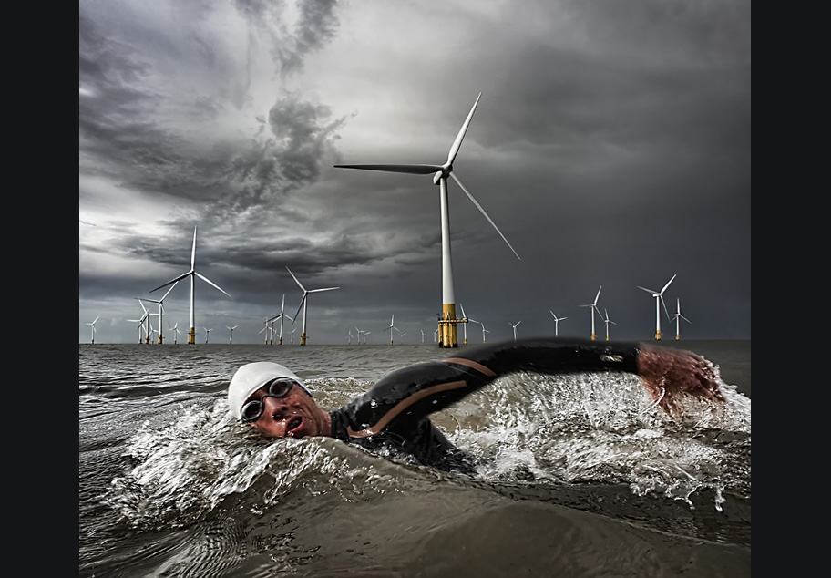 Male Triathlete swimming in the sea